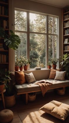 a couch sitting in front of a window filled with plants