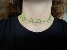 A choker necklace made with silver chain and green seed beads. Creates a wavy effect that adds a fun touch to any outfit! Green Adjustable Chain Necklace For Party, Green Tiny Beads Choker For Festivals, Green Beaded Choker Necklace For Party, Green Beaded Choker For Festivals, Trendy Festival Beaded Chain Choker, Green Beaded Choker For Party, Trendy Green Necklace For Party, Trendy Beaded Necklace With Tiny Beads For Parties, Trendy Tiny Beads Necklace For Party