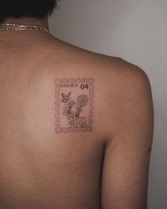 the back of a woman's shoulder with a stamp on it that says monaco