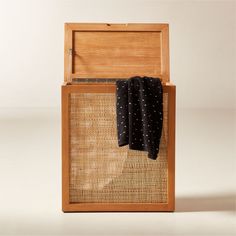 an open wooden box with two black and white polka dots on the cloth in it