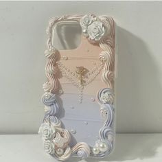 an iphone case with flowers and pearls on it