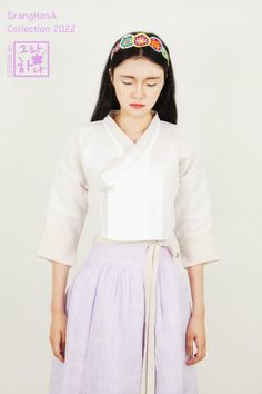 This is a natural white mosi(one of represeneted Korea tradition summer fabric/ramie fabric) constrast jeogori in GrangHana, has Korea tradition Mok-pan git(a kind of Korean tradition collars).   It is calm and neat mood jeogori that light grey tencel linen on Dongjeong(Putting fabric over on Hanbok collar)and Kkeutdong(part of sleeves edge) contrasted with natural white mosi fabric, can match easier with any color clothes.  This jeogori has beauty of Korean tradition and cool mood being able to do various styling though matching with waist skirt, dress and even ordinary clothes, adds cute mood by Yeonbong knot(a kind of tradition knots to resemble lotus bud),too. * Basic size : bust ~ 97cm, Hwa-jang (from back neck born to end length of sleeves) 60cm, back length 39cm * You can order basi South Korea Clothes, Korea Clothes, Color Clothes, Summer Fabrics, Body Size, Body Fit, South Korea, High Waisted Skirt, Light Grey