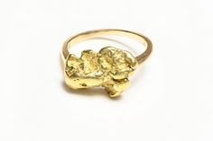 Vintage Gold Nugget Ring.Upgrade your style with our Vintage Gold Nugget Ring. Channel your inner gold digger with this quirky (and genuine!) piece. Perfect for any occasion (or just showing off). Get ready to strike gold!" This vintage 24K gold nugget ring is a beautiful piece of jewelry that will make a great addition to any collection. The ring features a unique design with a natural gold nugget as the centerpiece mounted in 14K yellow gold. Size 7. Ring care be resized upon request. Gold Hammered Nugget Rings, Gold Nugget Ring, Natural Gold Nugget, Ring Upgrade, Gold Digger, Genuine Love, Gold Nugget, Natural Gold, Ring Sale