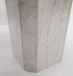 a large white marble vase sitting on top of a table