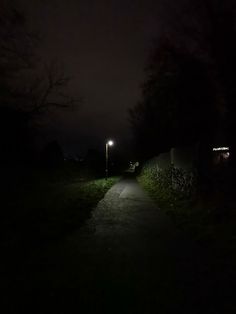 the path is lit up at night with no one on it or in the dark