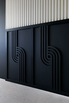 an art deco paneled room divider in black with white stripes on the wall