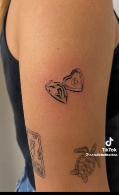 a woman's arm with tattoos on it and an image of a heart in the middle