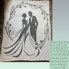 a cross stitch wedding pillow with the silhouette of a bride and groom