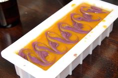 an orange and purple dessert sitting on top of a table