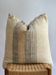 two pillows sitting on top of a wooden chair