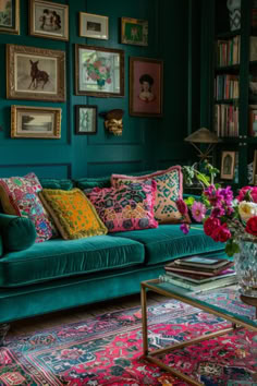 a living room filled with green couches and lots of colorful pillows on top of them