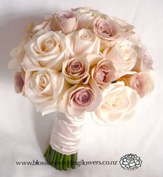 a bridal bouquet with white and pink roses