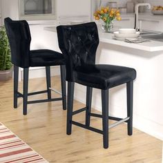 two black velvet bar stools in a kitchen