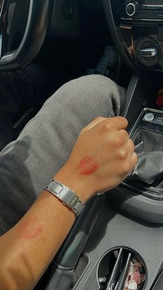 A male arm holding the steering stick of a car is covered with red lipstick kisses. The arm also wears a Casio watch Lipstick Marks On Boyfriend Aesthetic, Secret Couple Picture Ideas, Red Lipstick Kisses Boyfriend, Lipstick Kisses All Over Face Boyfriend, Couple Lipstick Mark, Secret Photos With Boyfriend, Lipstick On Boyfriend Face, Kiss Marks On Boyfriend, Secret Boyfriend Photos Aesthetic