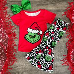 Adorable 2pc Outfit Includes Red Short Sleeve Top With Grinch Design And Matching Leopard Print And Grinch Design Bell Style Pants. Grinch Birthday Party Outfit, Playful Christmas Holiday Sets, Playful Cotton Sets For Holiday, Holiday Festive Red Set, Cute Fitted Christmas Sets, Cute Red Christmas Sets, Cute Cotton Holiday Sets, Cute Christmas Holiday Sets, Cute Cotton Sets For Holidays