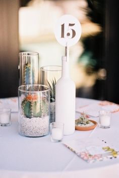 the table is set up with candles and succulents