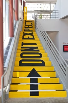 the stairs are painted yellow and black with an arrow