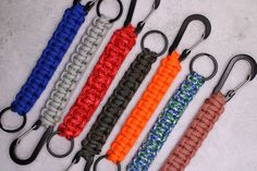 four different colored lanyards with black hooks