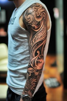 Person with a detailed and intricate full sleeve tattoo showing artistic patterns on their arm. Manly Sleeve Tattoos, Men’s Sleeve Tattoo, Sleeve Tattoos Men, Mens Sleeve Tattoo Ideas, Sleeve Tattoos Ideas, Black And Grey Sleeve