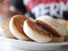 three pancakes on a plate with peanut butter