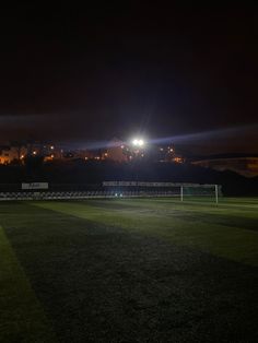 a soccer field at night with the lights on