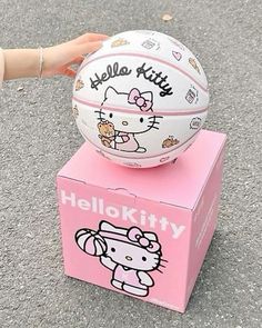 a hello kitty basketball sitting on top of a pink box