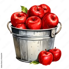 a bucket filled with red apples sitting on top of a table