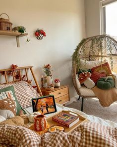 a bed room with a hanging chair next to a window