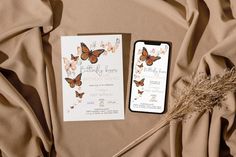 the wedding stationery is laid out on top of the bed, next to an iphone