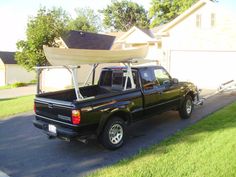 a pick up truck with a boat on the back of it's flatbed