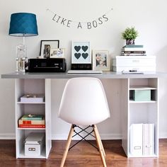 a white chair sitting in front of a desk with bookshelves on top of it