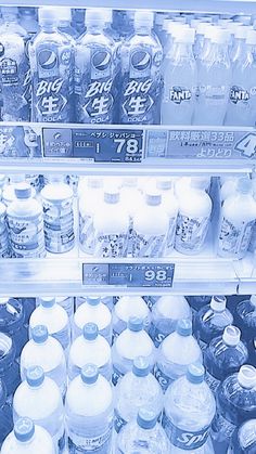 an open refrigerator filled with lots of bottled water