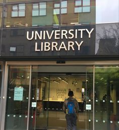 a man standing in front of a library