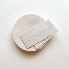 two business cards sitting on top of a white plate with the name martinin phoe