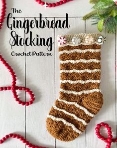 the gingerbread stocking crochet pattern is laying on a white wooden surface