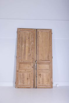 an open wooden door in a white room