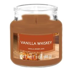 a jar of vanilla whiskey sits on a table