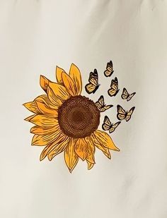 a sunflower with butterflies flying around it on a white sheet that has been embroidered onto