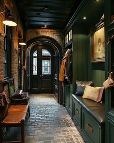 a hallway with green walls and brick flooring