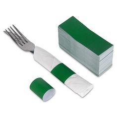 a fork, knife and napkin on a white surface with green tape next to it