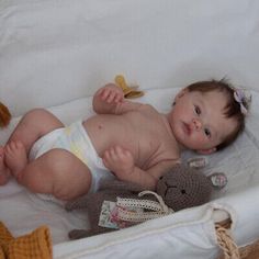 a baby laying in a crib with stuffed animals