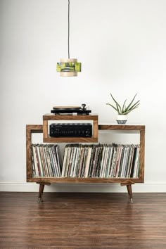 a record player sitting on top of a wooden shelf