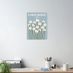 a flower market poster hangs above a desk