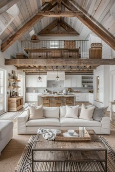 a living room filled with furniture next to a kitchen and dining area in a house