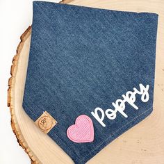 a piece of denim with the words happy written on it and a pink heart in the pocket