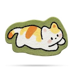 an orange and white cat is laying down on the green rugs that look like it's sleeping