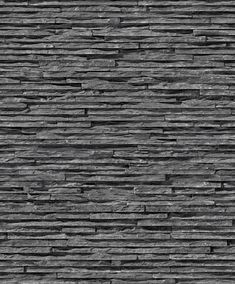 a black and white photo of a wall made out of stone bricks with no mortars