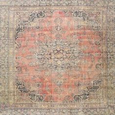 an orange and blue rug on a white background with lots of light colored details in the middle