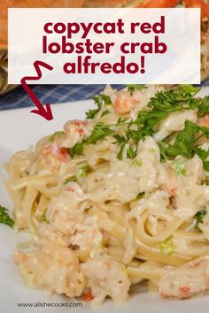 a white plate topped with pasta covered in sauce and garnished with parsley