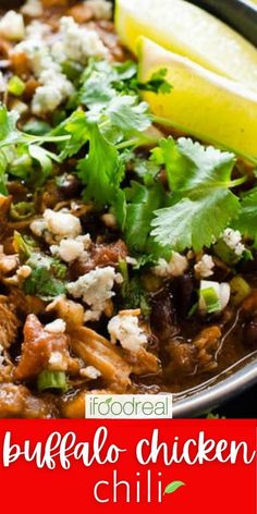 a bowl filled with chicken chili and garnished with cilantro, parsley and lemon wedges